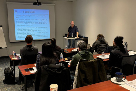 Illustration of an in-person training with an instructor and attendees
